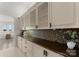 Butlers pantry with glass-front cabinets and granite countertop at 16100 Woolwine Rd, Charlotte, NC 28278