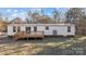 White single-wide manufactured home with wooden deck at 2029 Big Dipper Dr, Clover, SC 29710