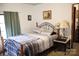 Bright bedroom with a metal framed bed and a wooden nightstand at 2118 Polkville Rd, Shelby, NC 28150