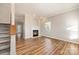 Living room with hardwood floors, fireplace, and view of the staircase at 6500 Forestrock Dr, Charlotte, NC 28269