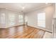 Living room with hardwood floors, sliding glass door, and neutral decor at 6500 Forestrock Dr, Charlotte, NC 28269