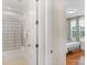 Simple bathroom with shower/tub combo and view of bedroom at 7014 Jolly Brook Dr, Charlotte, NC 28215