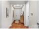 Bright hallway with hardwood floors and access to other rooms at 7014 Jolly Brook Dr, Charlotte, NC 28215