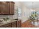 Kitchen with granite countertops, wine fridge, and breakfast area at 7014 Jolly Brook Dr, Charlotte, NC 28215