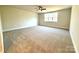 Spacious bedroom with neutral carpet and window at 959 Tamary Way # 29/30, Landis, NC 28088