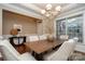 Formal dining room with chandelier, hardwood floors, and large windows at 10528 Royal Winchester Dr, Charlotte, NC 28277