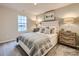 Bright bedroom with a full-size bed and window at 108 Mountain Bridge Way, Statesville, NC 28625