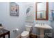 Light and airy powder room with pedestal sink and bird-themed art at 124 Gladstone Springs Rd, New London, NC 28127