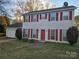 Two-story house with attached garage and red shutters at 1640 English Knoll Dr # 43, Matthews, NC 28105