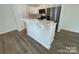 Kitchen island with marble countertop and white cabinets at 206 W Henderson St, East Spencer, NC 28144