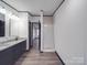 Modern bathroom with granite countertop, dark wood vanity, glass shower, and wood-look floor at 280 37Th Sw St, Hickory, NC 28602