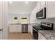 Kitchen with white cabinets, granite countertops, and stainless steel appliances at 3535 Clover Valley Dr, Gastonia, NC 28052