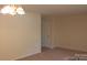 Spacious main room with light walls, carpeting and a chandelier at 4605 Coronado Dr, Charlotte, NC 28212