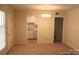 Main living area with carpet, light walls, and access to the kitchen at 4605 Coronado Dr, Charlotte, NC 28212