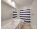 Bathroom with navy and white striped shower curtain at 5021 Markfield Ln, Monroe, NC 28110