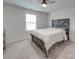 Bright bedroom with carpeted floor, a large window, and a ceiling fan at 5021 Markfield Ln, Monroe, NC 28110