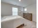 Bedroom with dresser and large window at 5021 Markfield Ln, Monroe, NC 28110