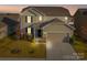 Two-story house with attached garage and landscaped lawn at 5021 Markfield Ln, Monroe, NC 28110