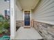 Inviting front entry with a black door and stone accents at 5021 Markfield Ln, Monroe, NC 28110