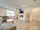 Spacious living room featuring a fireplace, large TV, and ample seating at 5021 Markfield Ln, Monroe, NC 28110