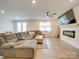 Living area with sectional sofa, fireplace, and large TV at 5021 Markfield Ln, Monroe, NC 28110