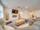 Spacious living room with sectional sofa and electric fireplace at 5021 Markfield Ln, Monroe, NC 28110