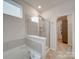Main bathroom with walk-in shower and separate tub at 5021 Markfield Ln, Monroe, NC 28110