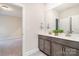 Double vanity bathroom with gray cabinets and a view of a bedroom at 562 Shepherd Ln, Clover, SC 29710