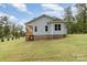 Light blue house with a porch and brick base, situated on a grassy lot at 562 Shepherd Ln, Clover, SC 29710