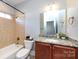 Bathroom with granite countertop, shower, and toilet at 592 S Main St, Belmont, NC 28054