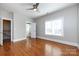 Spacious bedroom with hardwood floors and ceiling fan at 592 S Main St, Belmont, NC 28054