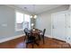 Bright dining area with hardwood floors and a charming wooden table at 592 S Main St, Belmont, NC 28054