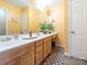 Bathroom boasts double sinks, wood cabinets, and a modern look at 7909 Lawyers Rd, Charlotte, NC 28227