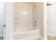 Updated bathroom with white tiled bathtub surround and built-in shelving at 8127 Paw Club Dr, Charlotte, NC 28214