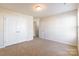 Well-lit bedroom with double doors leading to a closet and hallway at 8127 Paw Club Dr, Charlotte, NC 28214