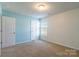 Bright bedroom with neutral walls, carpet, and ample closet space at 8127 Paw Club Dr, Charlotte, NC 28214
