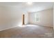 Bright bedroom with neutral carpeting and large window providing natural light at 8127 Paw Club Dr, Charlotte, NC 28214