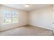 Spacious bedroom featuring a large window and neutral decor at 8127 Paw Club Dr, Charlotte, NC 28214