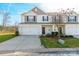 Two-story townhome with attached garage and landscaping at 8127 Paw Club Dr, Charlotte, NC 28214