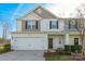 Two-story townhome featuring a neutral color palette and attached garage at 8127 Paw Club Dr, Charlotte, NC 28214