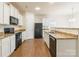 Modern kitchen featuring granite countertops and stainless steel appliances at 8127 Paw Club Dr, Charlotte, NC 28214