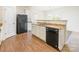 Modern kitchen with granite countertops, white cabinets, and stainless steel appliances at 8127 Paw Club Dr, Charlotte, NC 28214