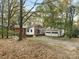 Brick house with a detached garage and mature trees at 1026 Jefferson Dr, Charlotte, NC 28270