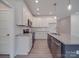 Modern kitchen with white cabinets, granite countertops, stainless steel appliances, and a kitchen island at 1140 Forest Dr, Marshville, NC 28103