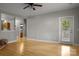 Spacious living room with hardwood floors and access to a balcony at 19744 Feriba Pl, Cornelius, NC 28031