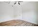 Bright bedroom with wood-look floors, ceiling fan, and door to hallway at 209 Westover Ave, Kannapolis, NC 28081