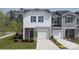 Two-story townhome with gray and white siding, two-car garage and landscaping at 3483 Backwater St, Concord, NC 28027