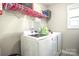 Laundry room with washer, dryer, and shelving at 3877 Lake Breeze Dr, Sherrills Ford, NC 28673