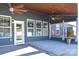 Covered patio with ceiling fan, screened sides and door leading to the backyard at 3877 Lake Breeze Dr, Sherrills Ford, NC 28673