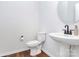 Bathroom with white pedestal sink, toilet, and round mirror at 457 Shallowford Dr # 60, Rock Hill, SC 29732